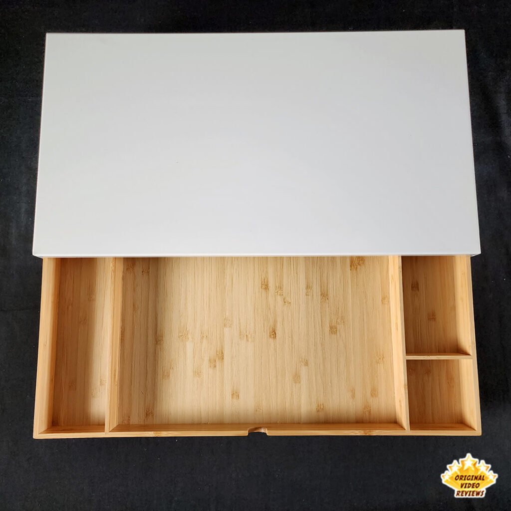 Top-down view of the IKEA ELLOVEN Monitor Stand with Drawer, showing the open bamboo drawer with fixed compartments.