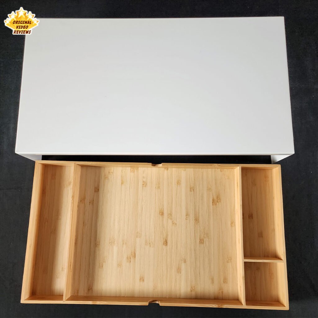 Top view of the IKEA ELLOVEN Monitor Stand with the bamboo drawer fully pulled out, showing fixed compartments.