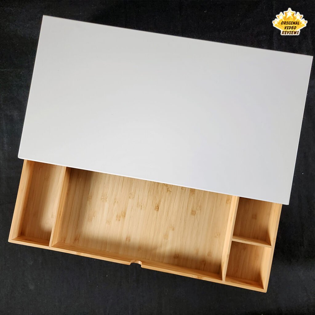 Top view of the IKEA ELLOVEN Monitor Stand with the bamboo drawer half open, showing partially visible compartments.