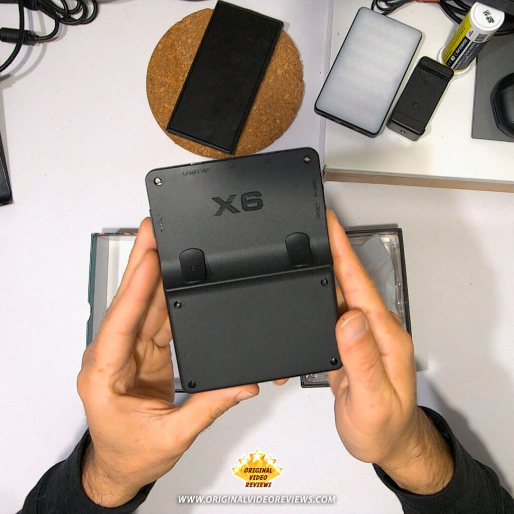 Back view of the X6 handheld retro gaming console with rear action buttons and X6 logo.