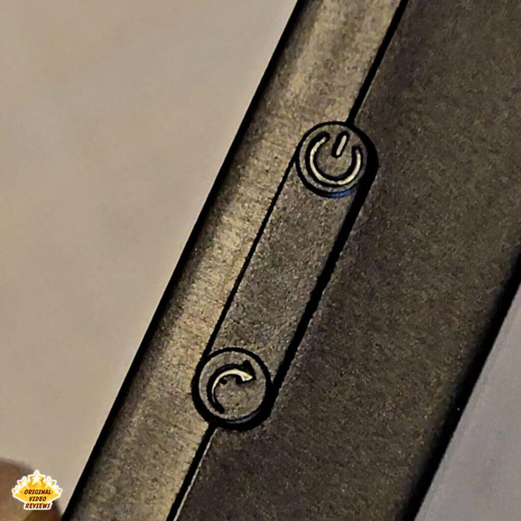 Close-up of the power and reset icons on the side of the X6 handheld gaming console