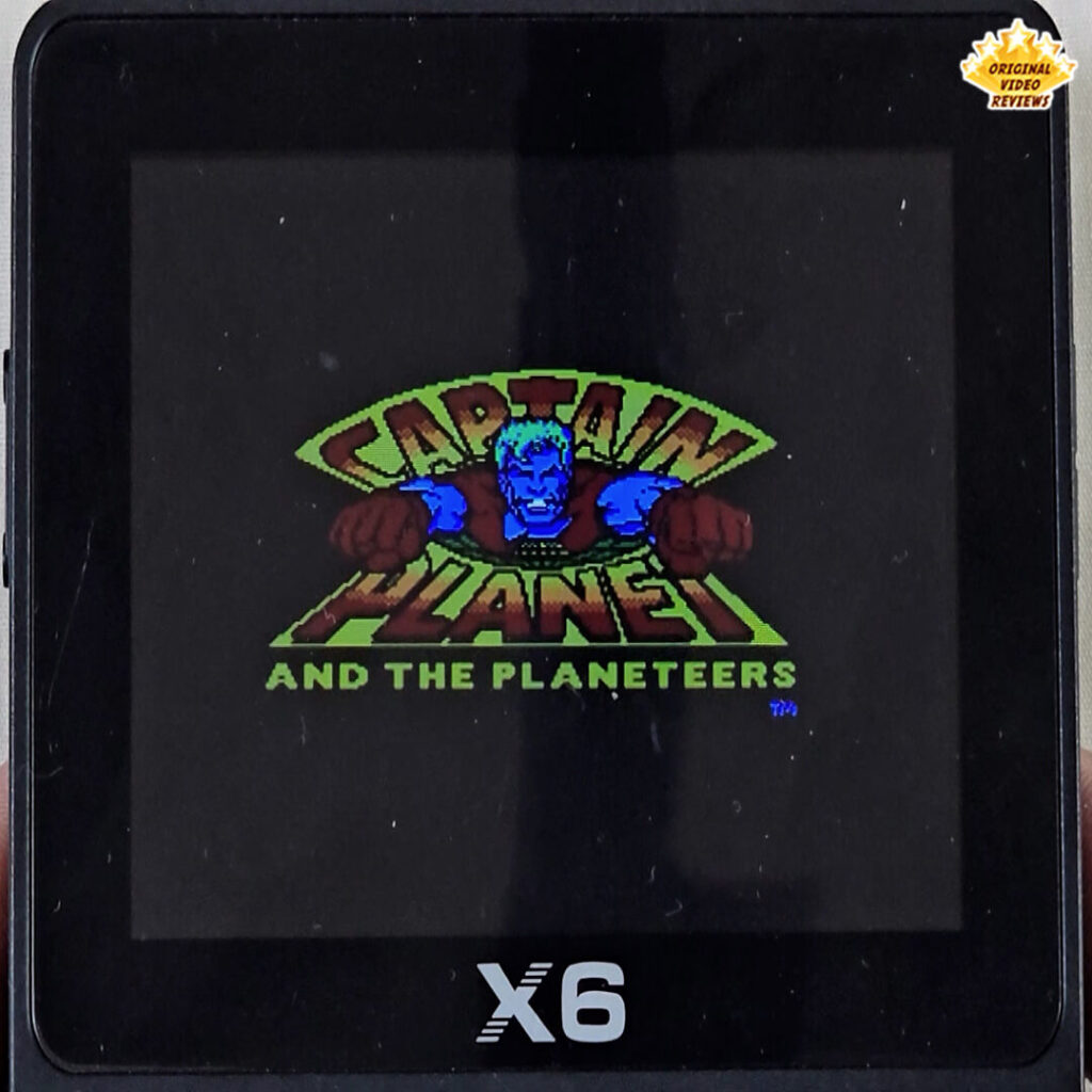 X6 handheld console showing the title screen of Captain Planet and the Planeteers, with the superhero flying forward.