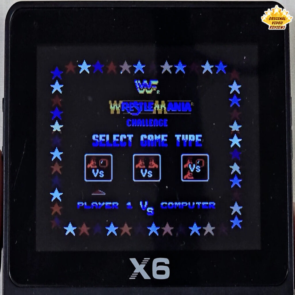 X6 handheld console displaying the game type selection screen of the retro wrestling game WWF WrestleMania Challenge.