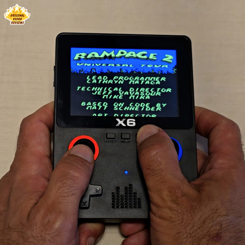 X6 handheld console displaying the title and credits screen of the retro game Rampage 2: Universal Tour.