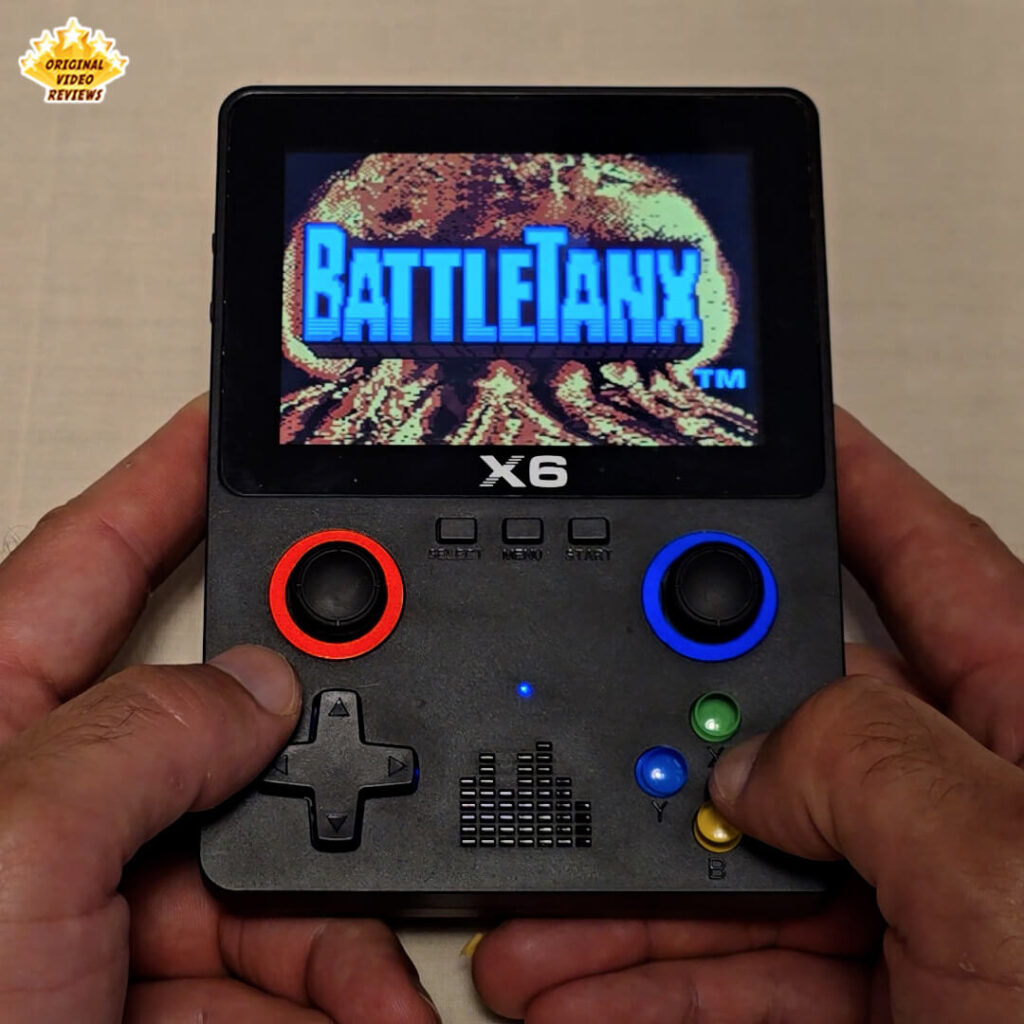 X6 handheld console displaying the title screen of the retro game BattleTanx.