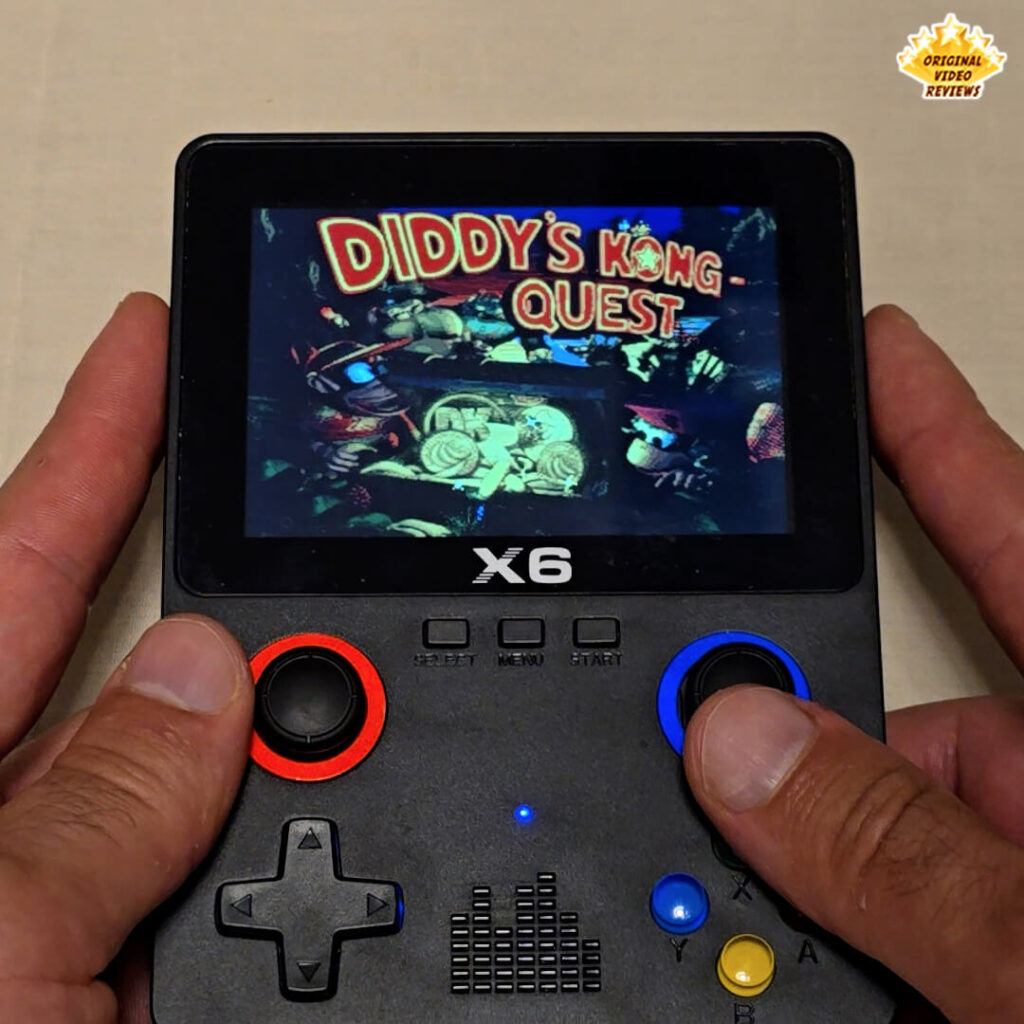 X6 handheld console displaying the title screen of the game Diddy's Kong Quest.