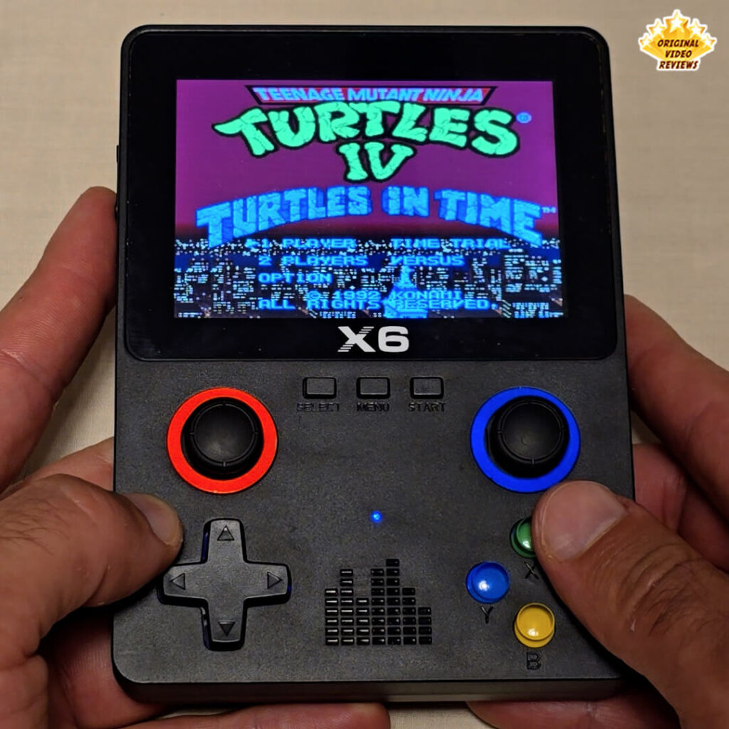 X6 handheld console showing a corrupted screen with unreadable text and graphics glitches.