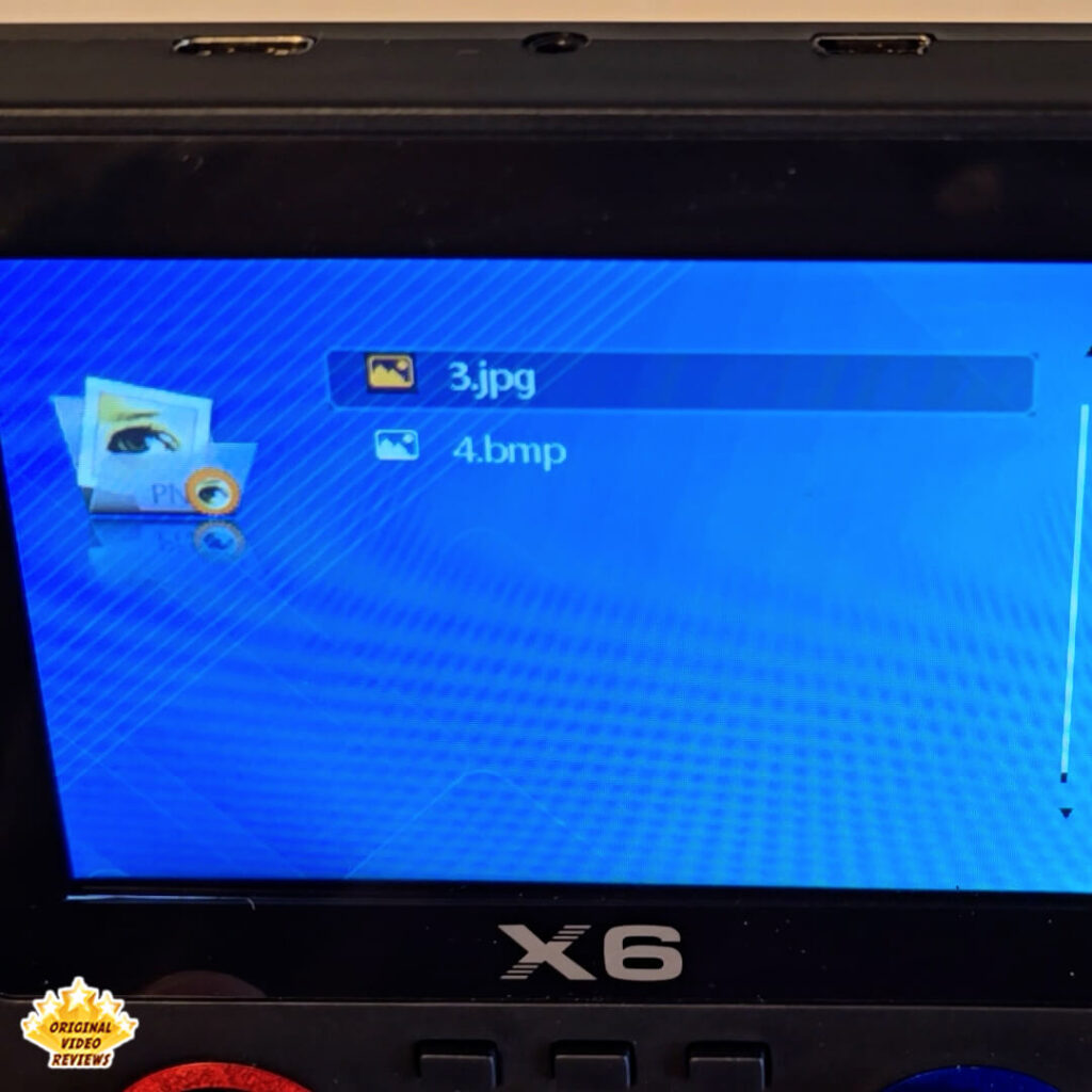 Close-up of the X6 handheld retro gaming console showing its file manager screen with image files listed.