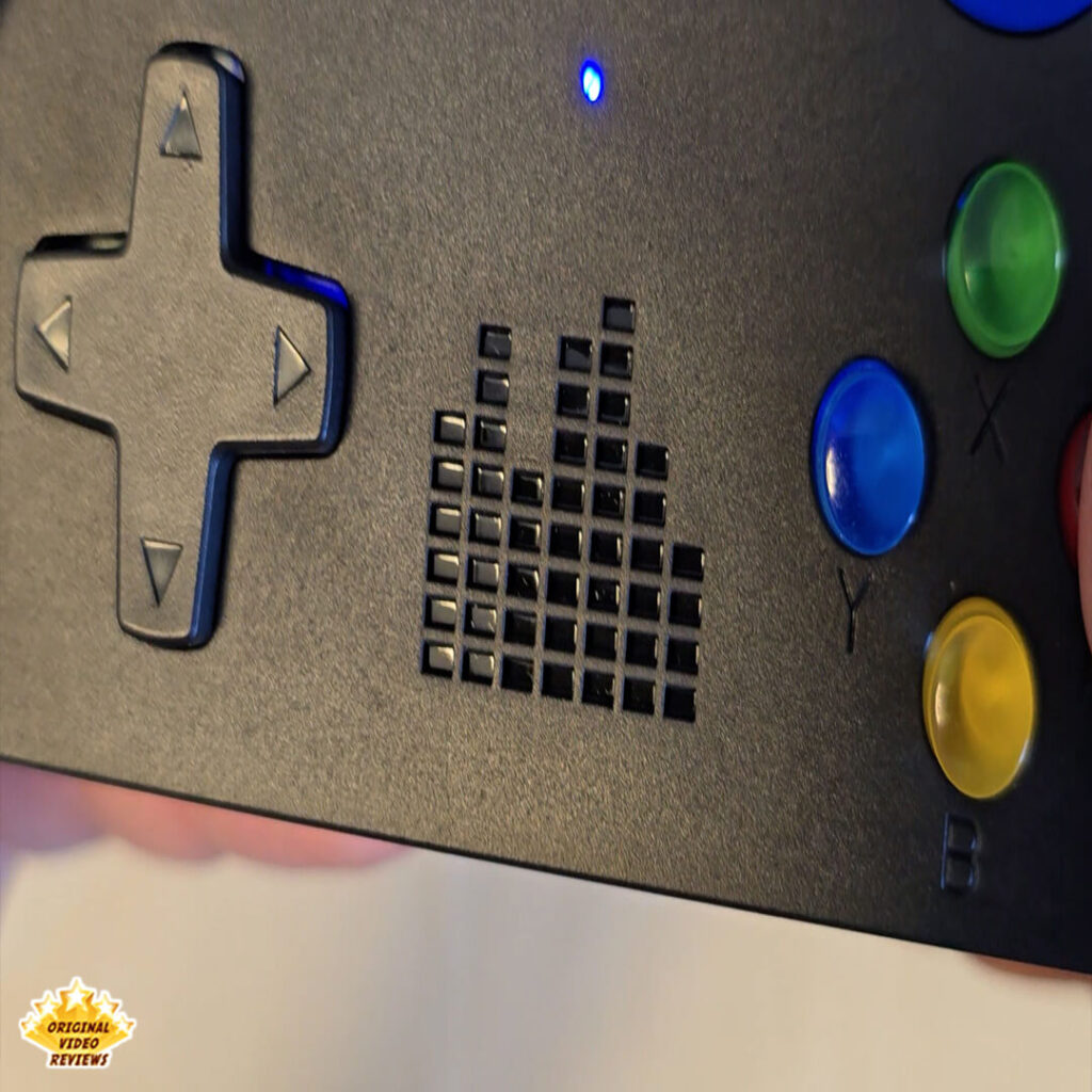 Close-up view of the X6 retro gaming console's directional pad and action buttons.