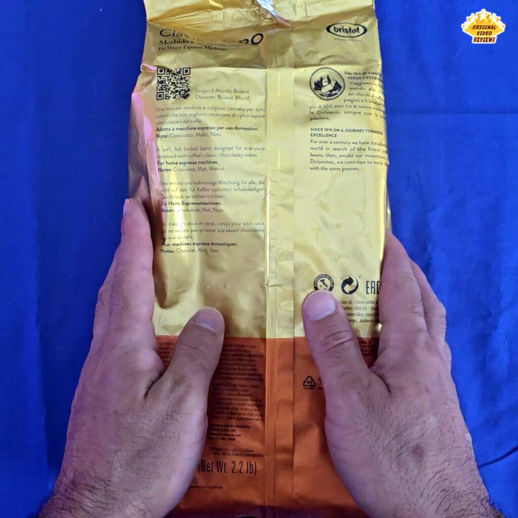 The OVR Guy holding the Bristot Classico Oro coffee beans package, showing the back side with product information and details during the review.