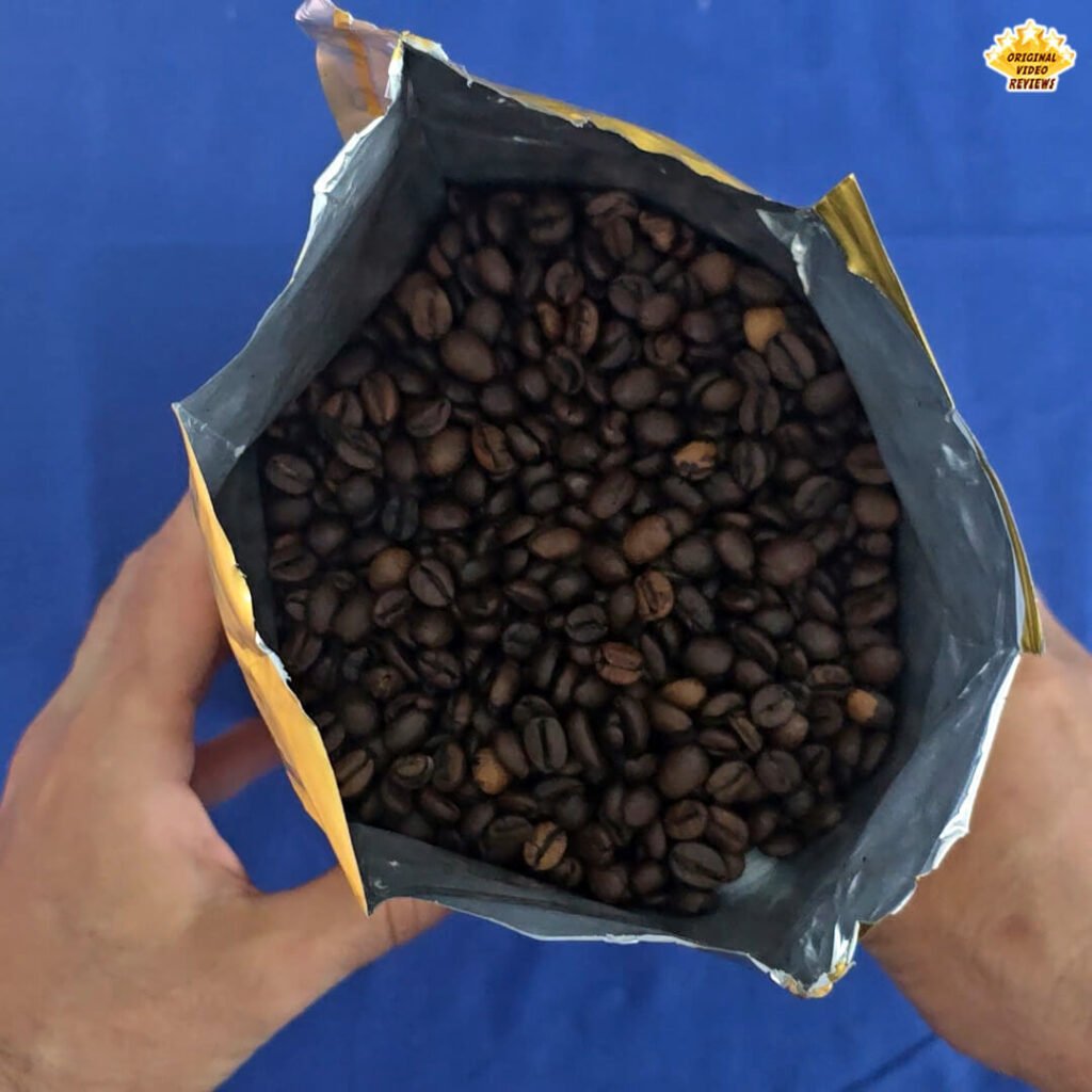 Top view of the freshly opened Bristot Classico Oro coffee beans package, showing the rich, dark beans inside as part of The OVR Guy’s review.