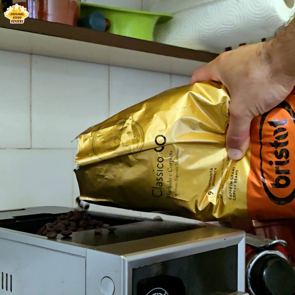 The OVR Guy pouring Bristot Classico Oro coffee beans into the grinder compartment of a BEANS fully automatic espresso machine.