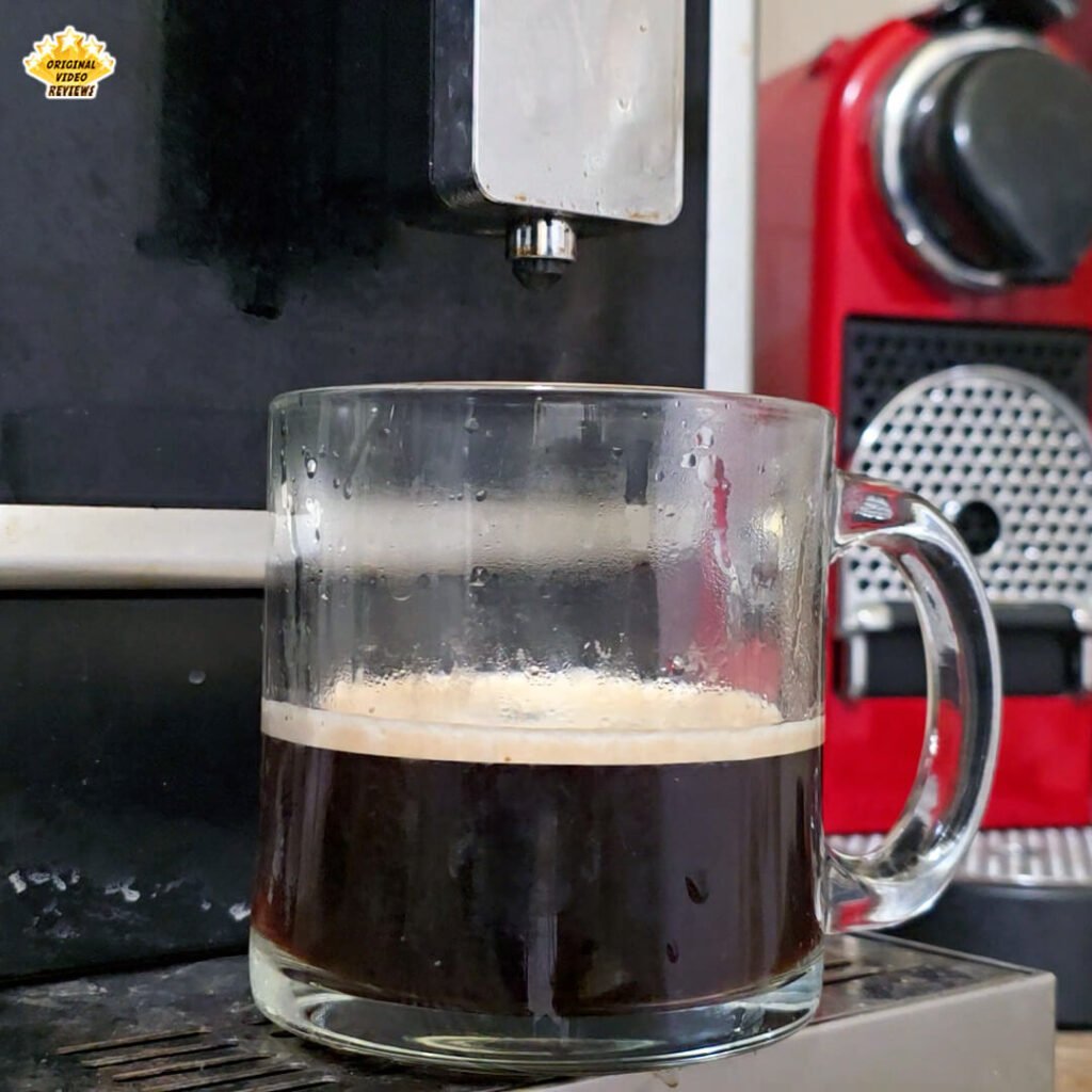 A glass mug filled with a double espresso and hot water, creating an Americano-style coffee using Bristot Classico Oro beans. The OVR Guy highlights the fine crema and balanced roast in this review shot.