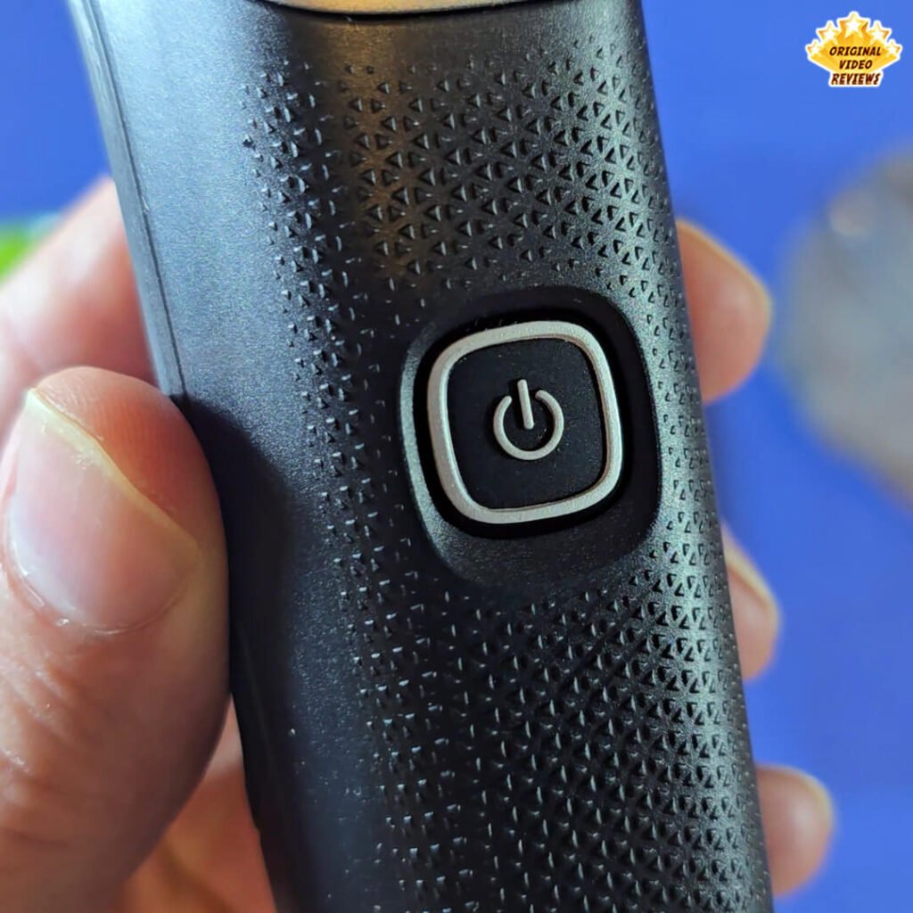 Close-up of the Philips Norelco Multigroom 5000 MG5970/49 power button (ON/OFF) and textured grip.