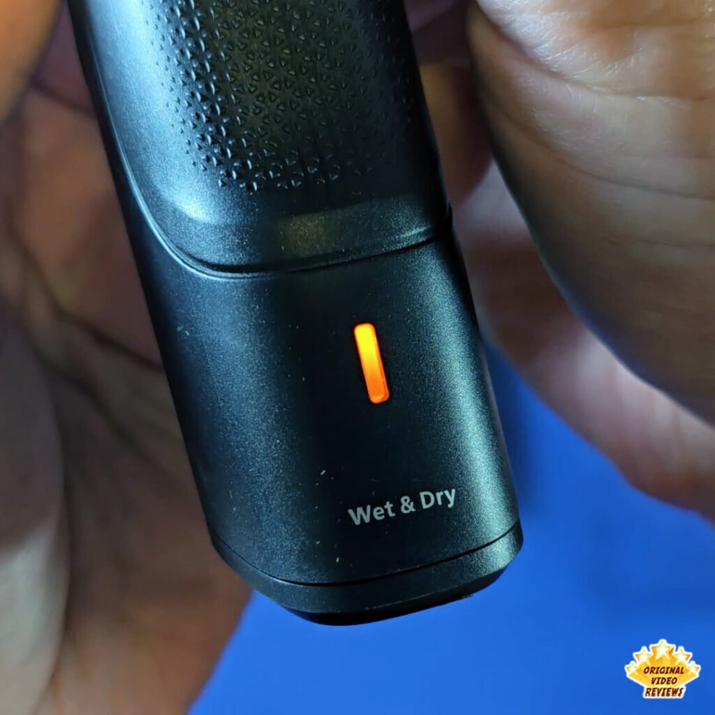 Close-up of the Philips Norelco Multigroom 5000 MG5970/49 low-battery orange indicator light and Wet & Dry label.