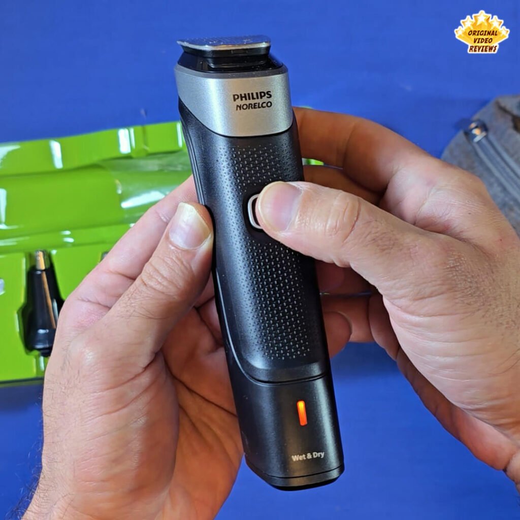 The OVR Guy pressing the power button on the Philips Norelco Multigroom 5000 MG5970/49, showing the orange low-battery indicator light.
