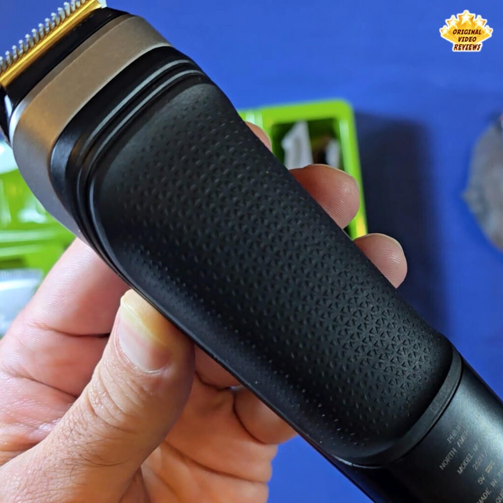 Close-up of the Philips Norelco Multigroom 5000 MG5970/49 bottom side showing the charging port and the textured rubber grip.