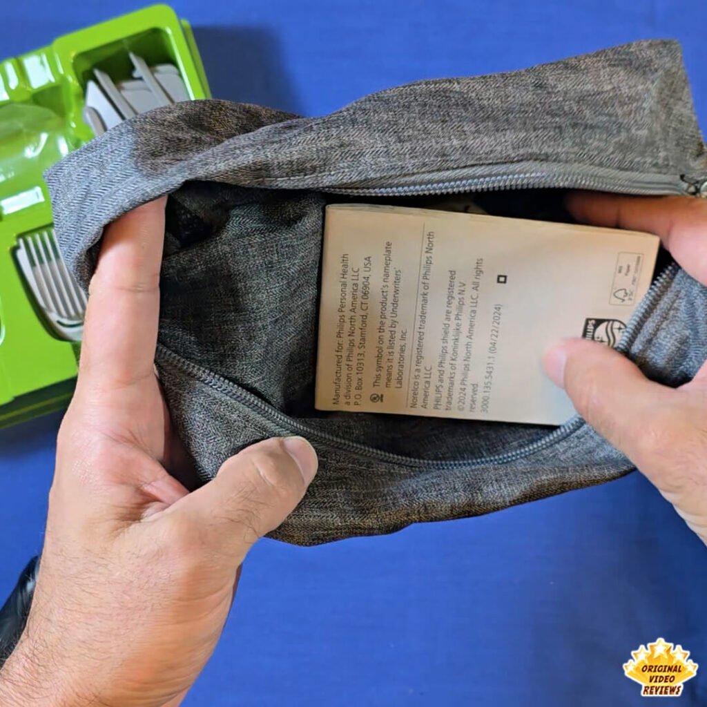 The OVR Guy emptying the Philips Norelco Multigroom 5000 MG5970/49 travel pouch to show its contents.