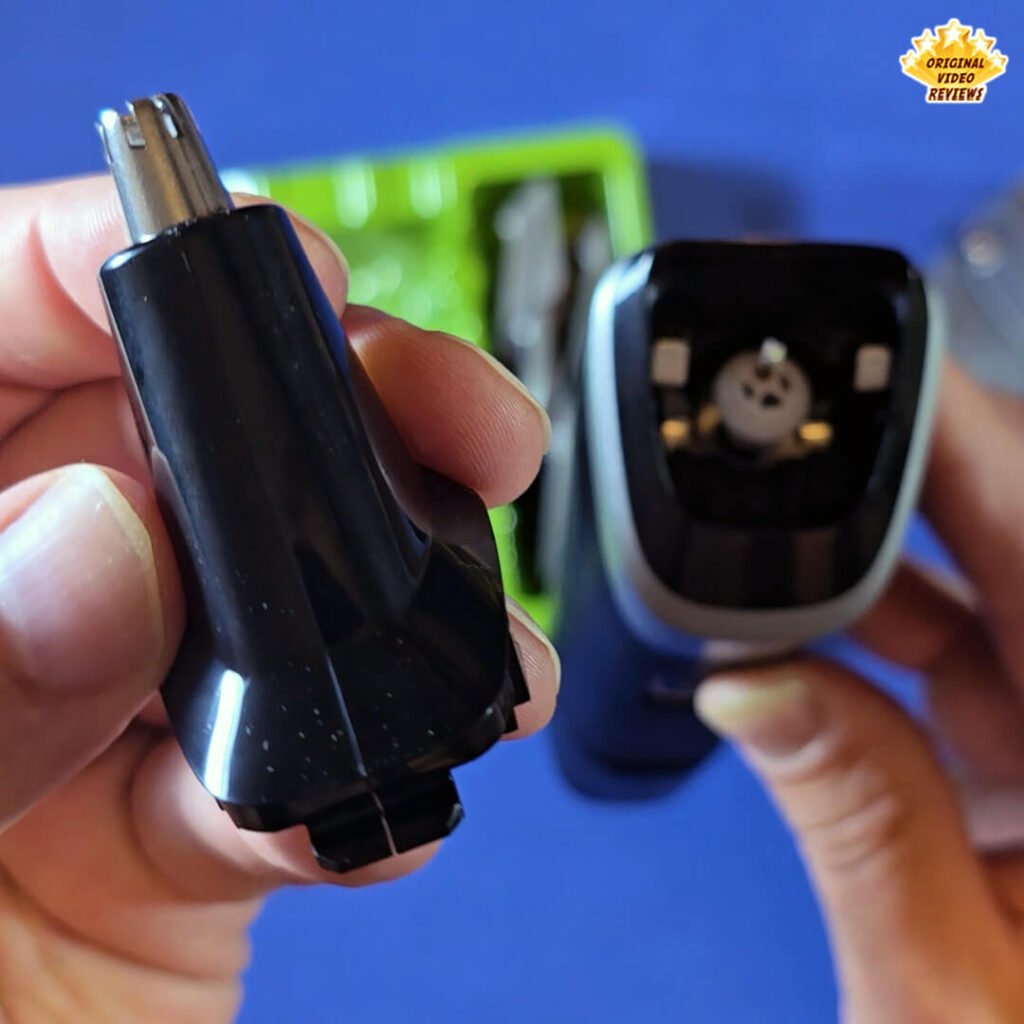 Close-up of the Philips Norelco Multigroom 5000 MG5970/49 nose and ear trimmer attachment being held next to the main trimmer body.