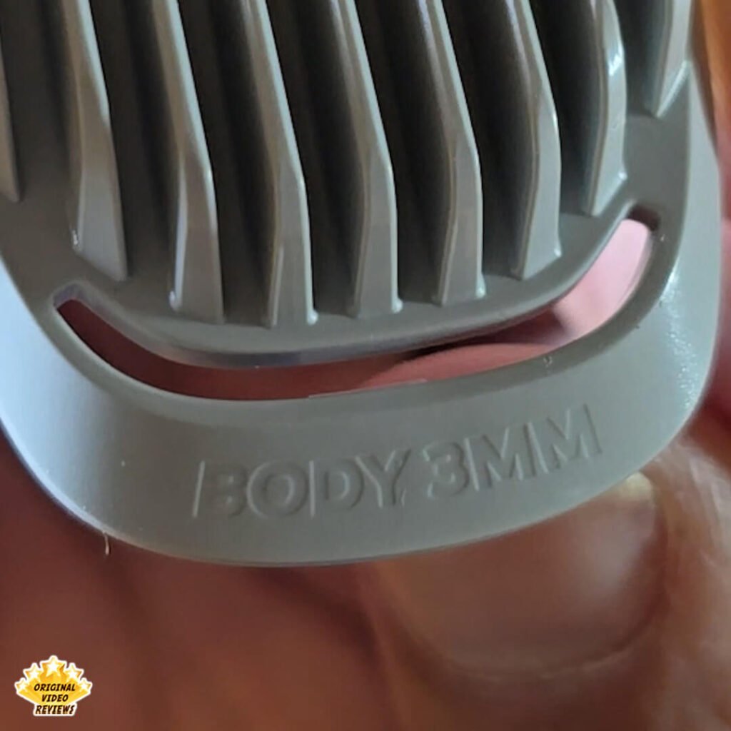 Close-up of the Philips Norelco Multigroom 5000 3 mm body guard comb attachment labeled “BODY 3 MM.”