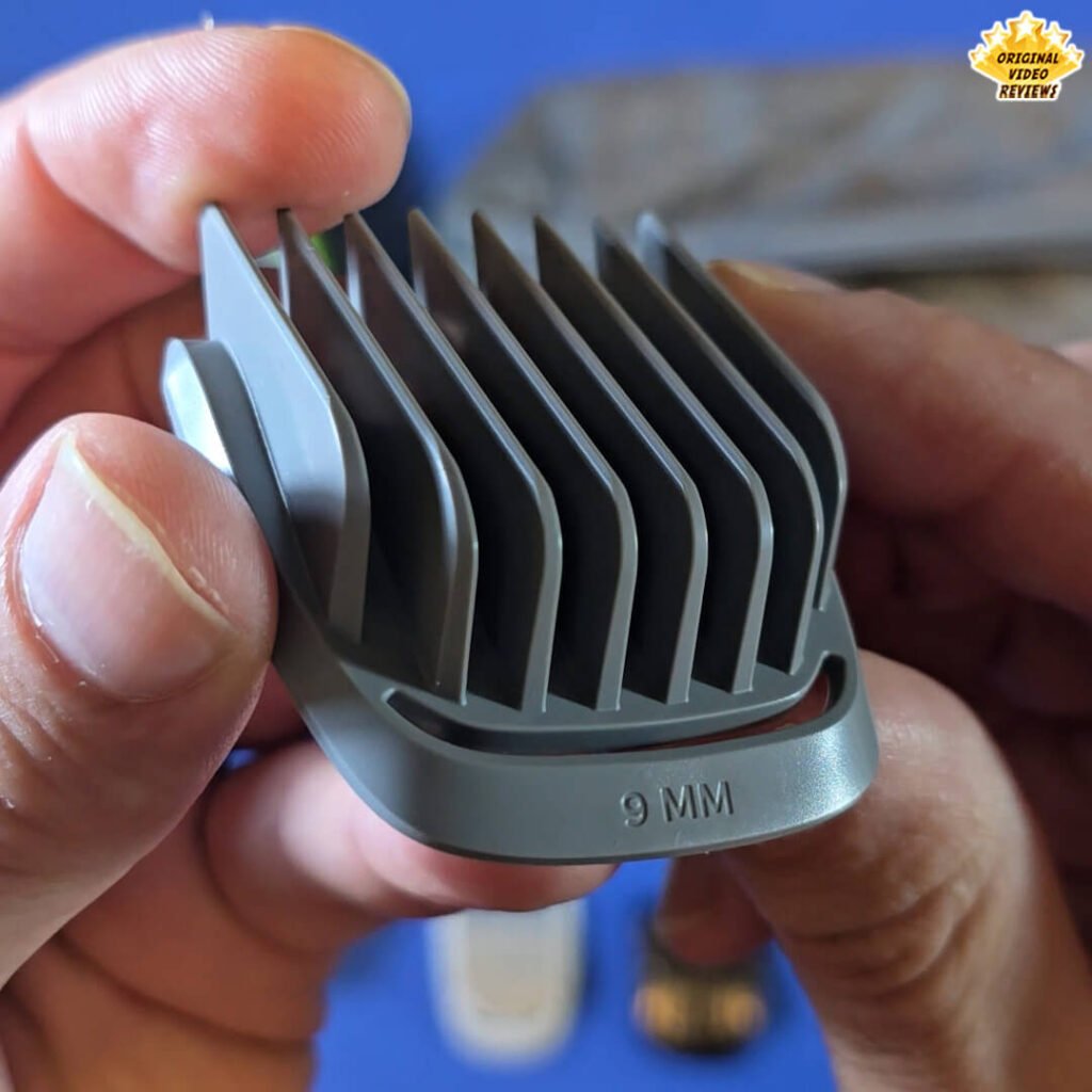 Close-up of the Philips Norelco Multigroom 5000 9 mm gray hair comb attachment labeled “9 MM.”