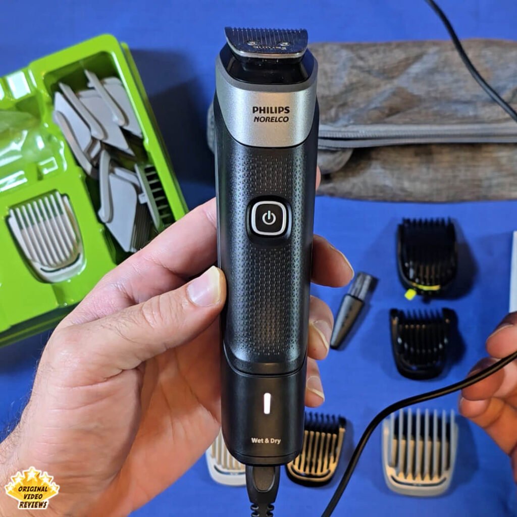 The Philips Norelco Multigroom 5000 (MG5970/49) charging via USB, with the white LED indicator light on.