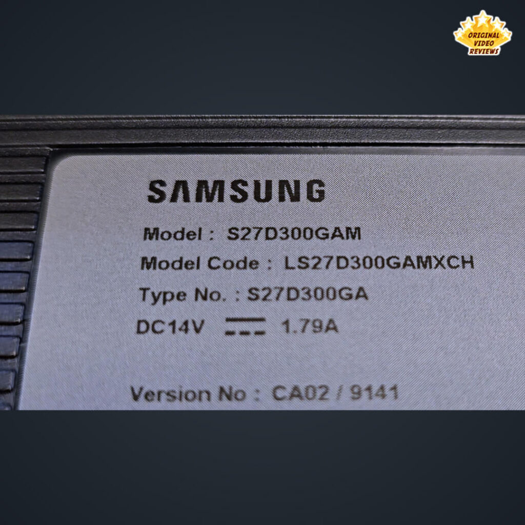 Close-up of the Samsung Essential Monitor S3 identification label showing model S27D300GAM and power requirements.