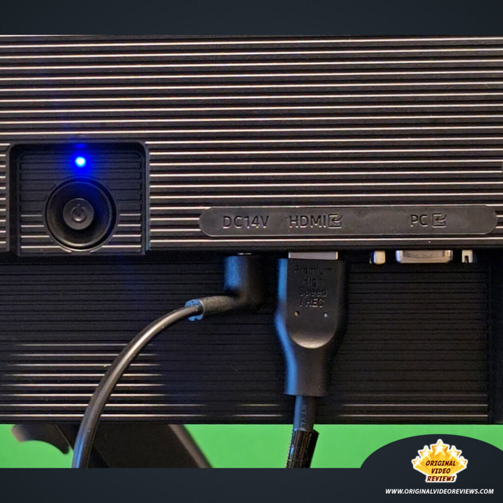 Macro shot of the Samsung Essential Monitor S3 rear ports with power cable and a Premium High Speed HDMI cable connected.