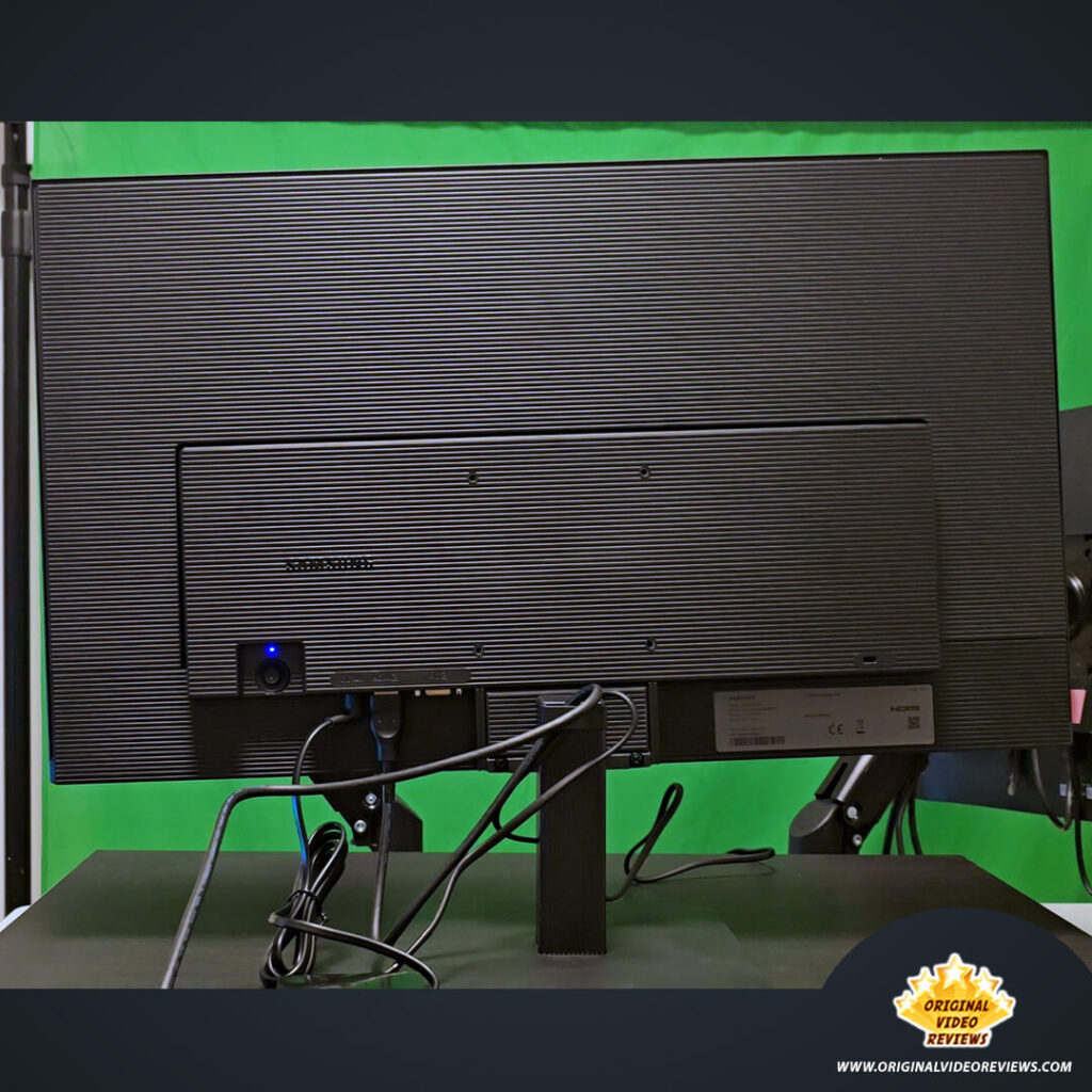 Rear view of the Samsung Essential Monitor S3 showing the cable management clip organizing the power and HDMI cords.