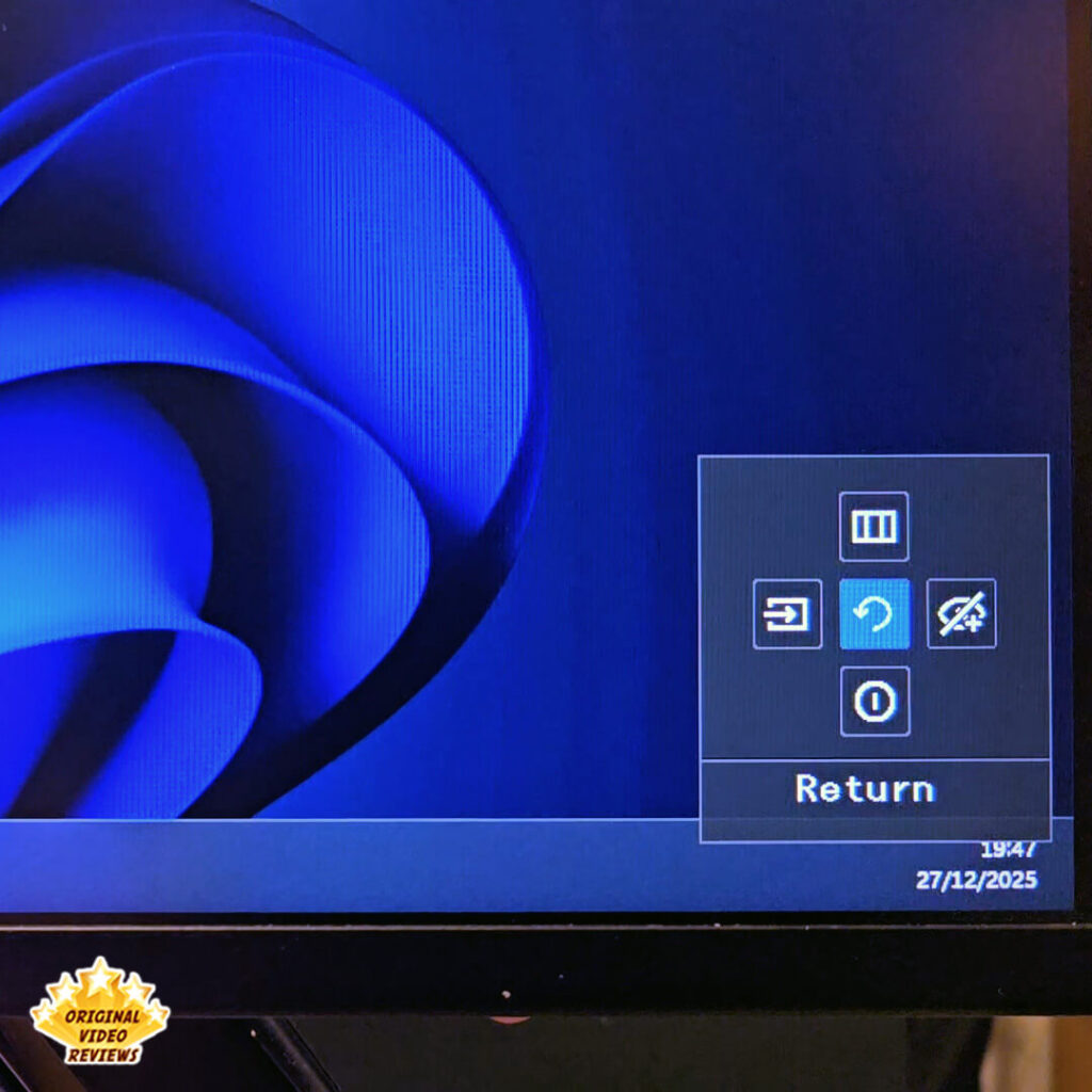 Close-up of the Samsung Essential Monitor S3 on-screen display (OSD) menu showing navigation icons for source, menu, and power.