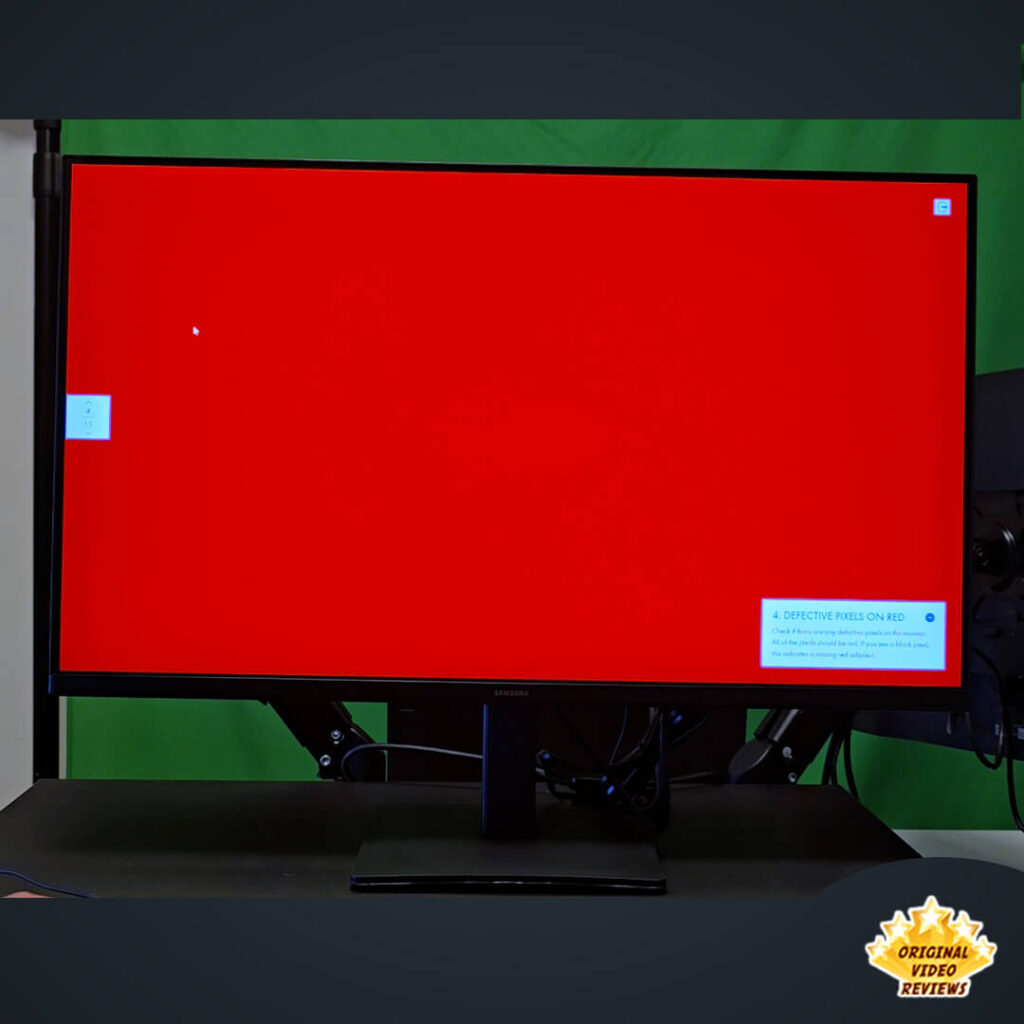 Samsung Essential Monitor S3 27-inch display performing a full-screen red color test to check for defective pixels.