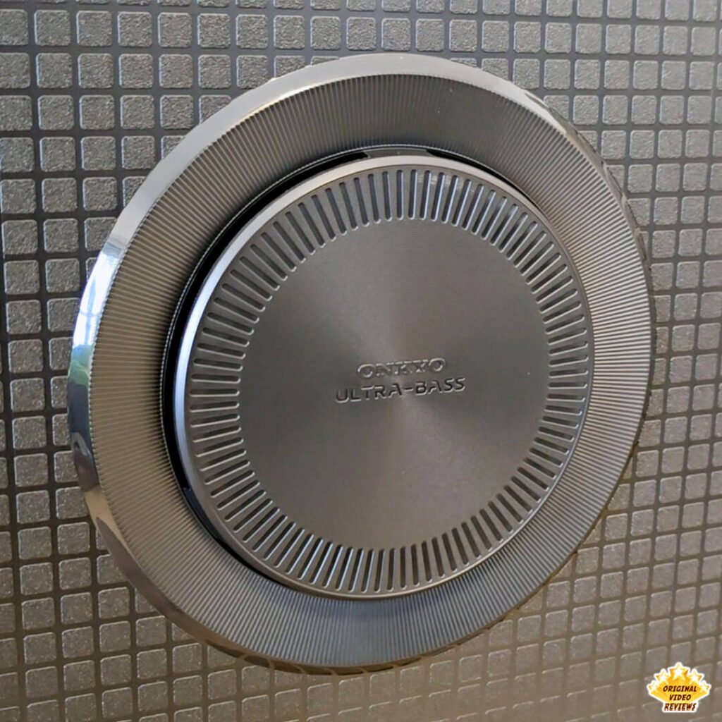 Angled close-up of the ONKYO ULTRA-BASS integrated subwoofer on the back panel of the TCL P89K 65-inch 4K QLED TV, part of a comprehensive review by Original Video Reviews.