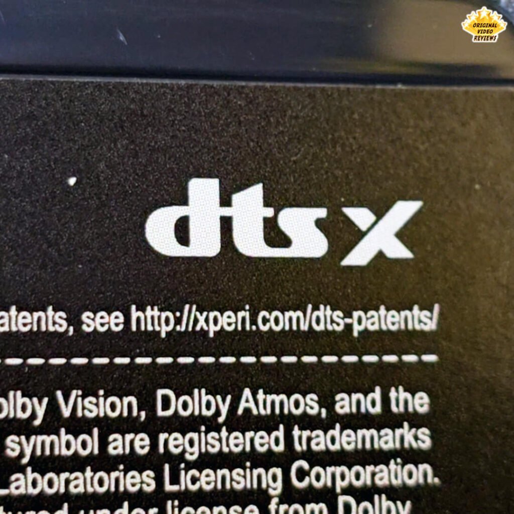 Close-up of DTS:X, Dolby Vision, and Dolby Atmos branding on the back of the TCL P89K 65-inch 4K QLED TV, part of a review by Original Video Reviews.