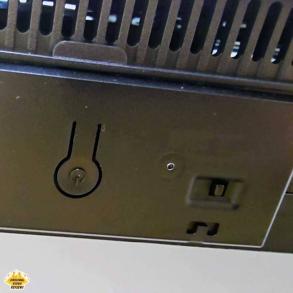 Close-up of the physical power button and the built-in microphone privacy switch on the bottom of the TCL P89K 65-inch 4K QLED TV, from a review by Original Video Reviews.