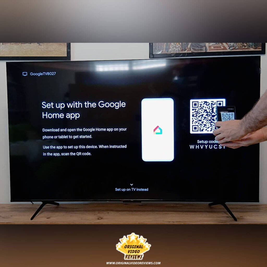The OVR Guy scanning the Google Home app QR code on the TCL P89K 65-inch QLED TV screen to begin the setup process, featured by Original Video Reviews.