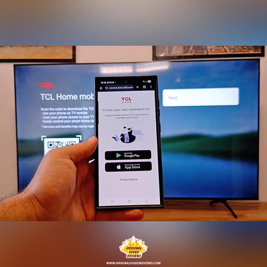 The OVR Guy holding a smartphone showing the TCL Home app download page (Google Play and App Store) to sync with the TCL P89K 65-inch QLED TV, from a review by Original Video Reviews.