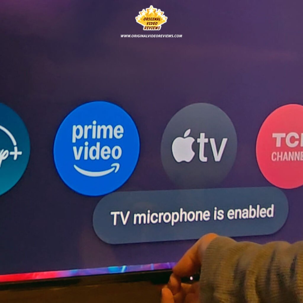 Close-up of the TCL P89K screen displaying the "TV microphone is enabled" notification as The OVR Guy toggles the physical hardware switch, part of a privacy and voice control test by Original Video Reviews.