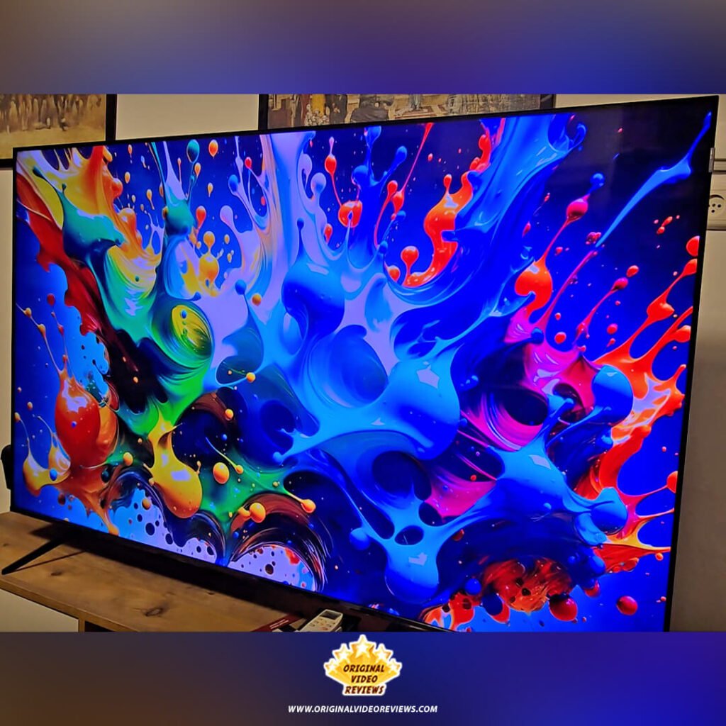 A vibrant 4K demonstration video on the TCL P89K 65-inch QLED TV showing high-contrast abstract paint splashes in blue, yellow, and orange, from a review by Original Video Reviews.