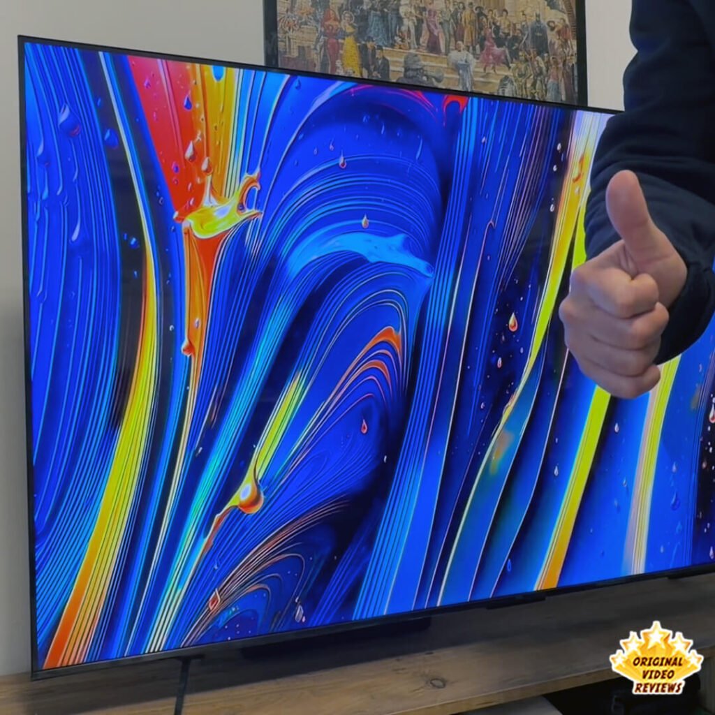 The OVR Guy giving a thumbs up in front of the TCL P89K 65-inch 4K QLED TV, inviting viewers to follow Original Video Reviews for more informative content that is fun to watch.