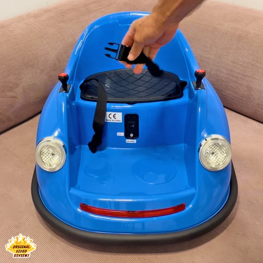 Hand buckling the black safety harness clip on the Electric Bumper Car for Kids seat