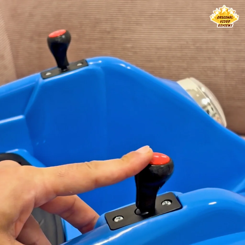 Extreme close-up of the red steering joystick knob on the Electric Bumper Car for Kids with a finger pressing the button on top