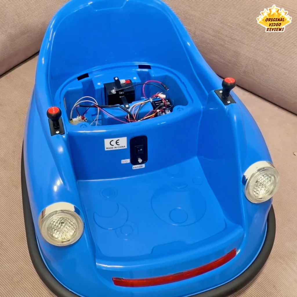 Interior of the Electric Bumper Car for Kids with the seat cushion removed, exposing the battery and internal wiring