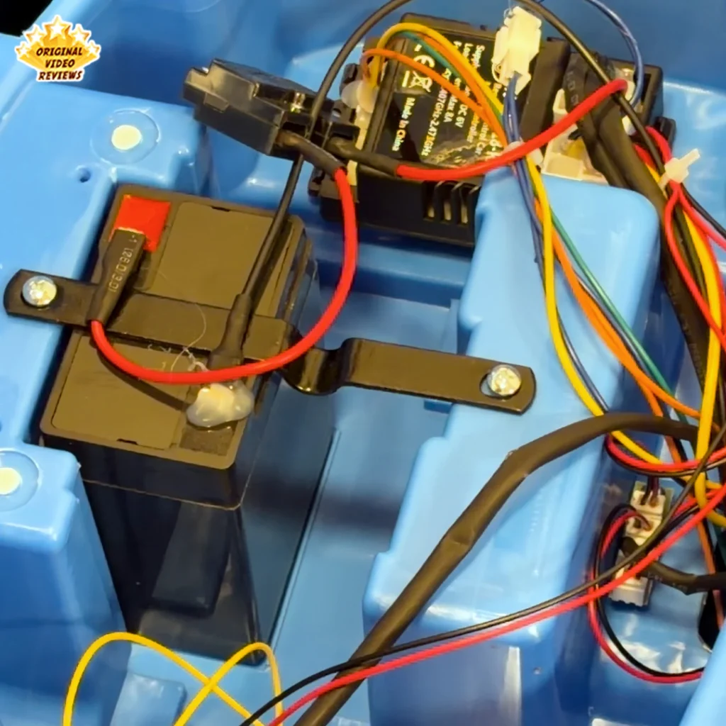 Extreme close-up of the sealed 12V battery and control unit wiring inside the Electric Bumper Car for Kids
