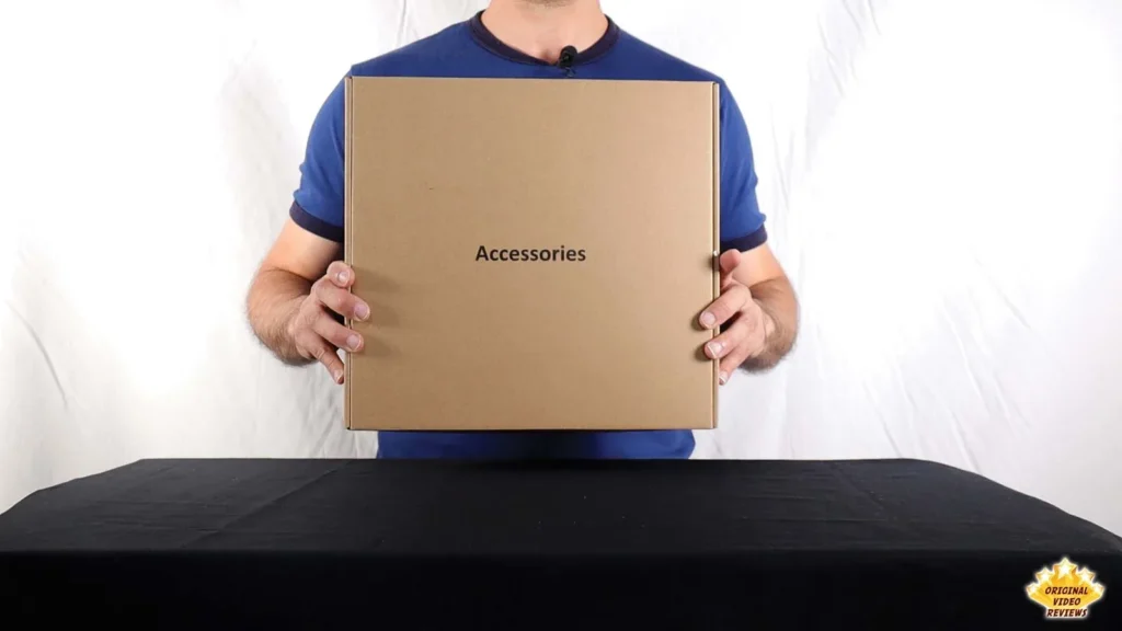 Reviewer holding the small accessories box that comes with the AIRPULSE A100