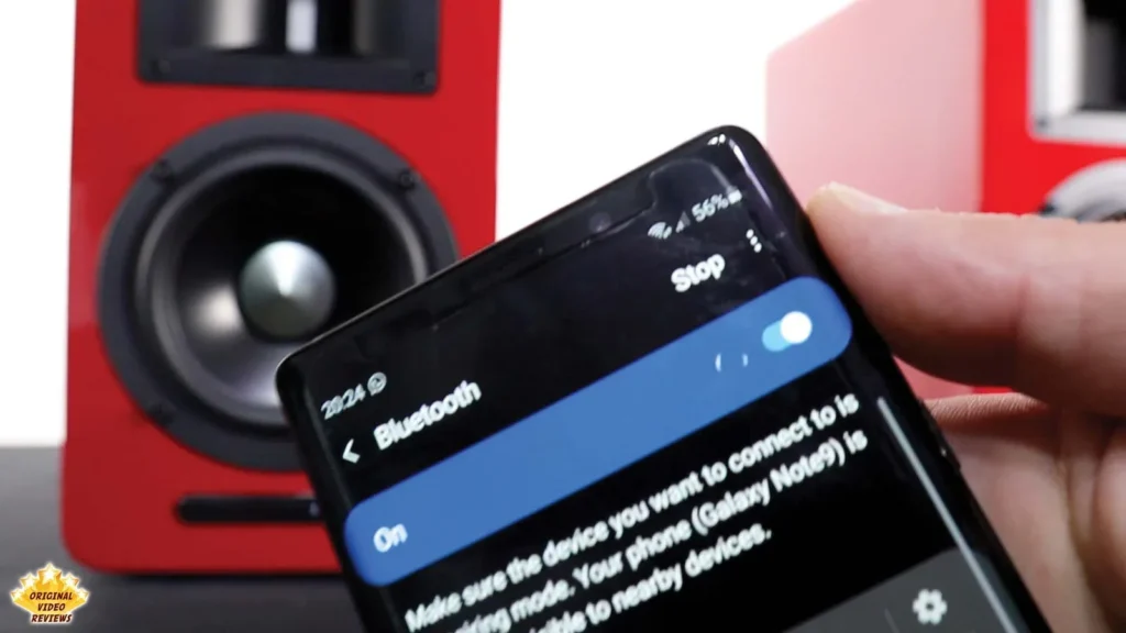 Phone Bluetooth settings screen turned on next to an AIRPULSE A100 speaker