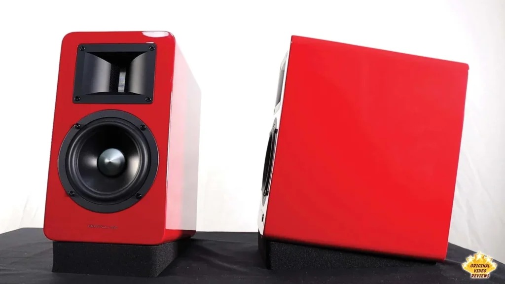 One red AIRPULSE A100 speaker facing forward next to another turned to show its side