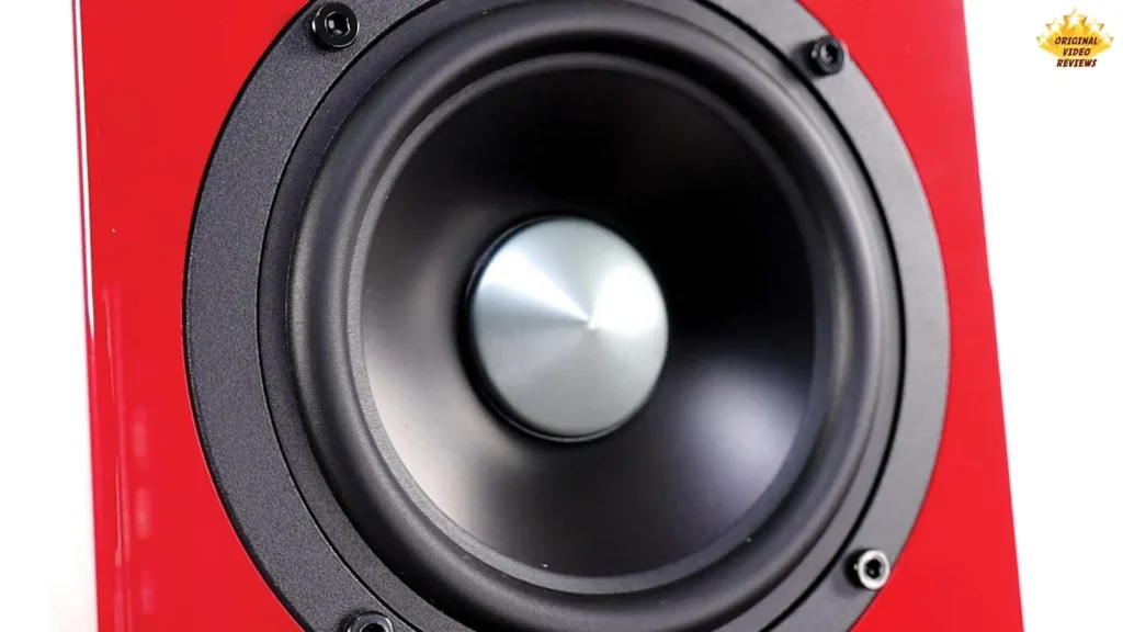 Close-up of the aluminum cone woofer on a red AIRPULSE A100 speaker
