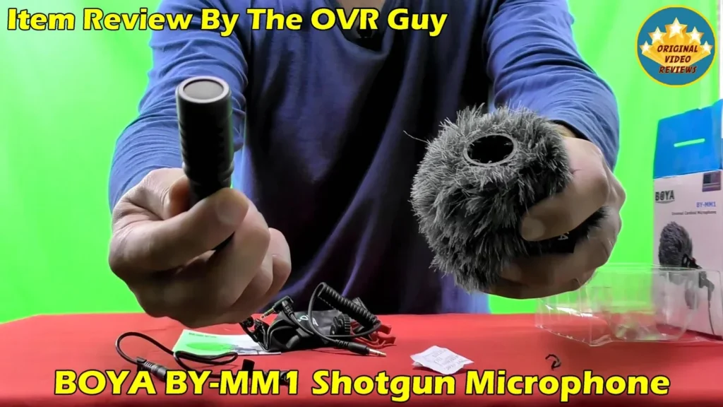 Rear of the BOYA BY-MM1 microphone and its windshield held in both hands