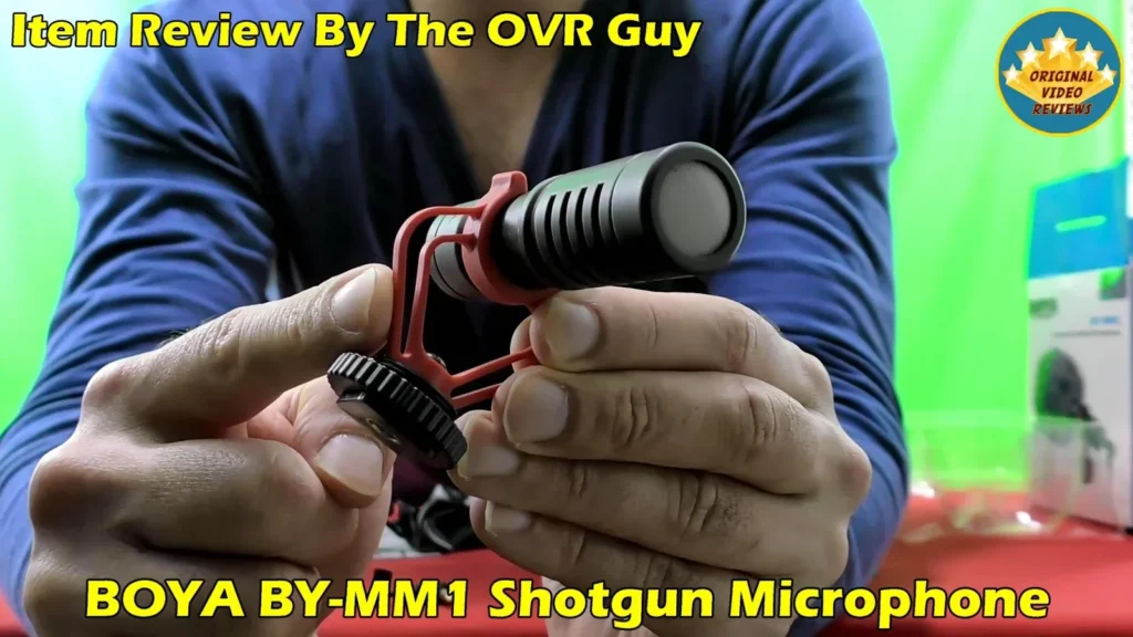 The BOYA BY-MM1 microphone on its shock mount held in hand