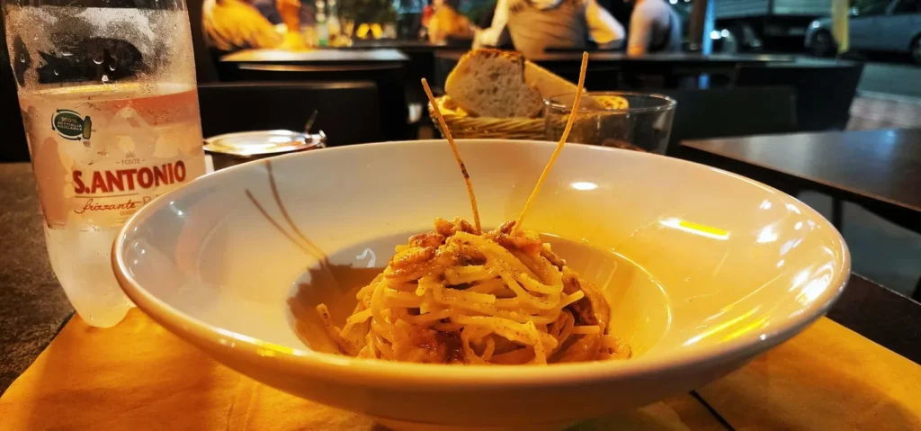 Plate of pasta carbonara on a table at B&B Baldassarre in Milan